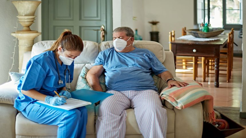 healthcare worker takes notes with masked patient