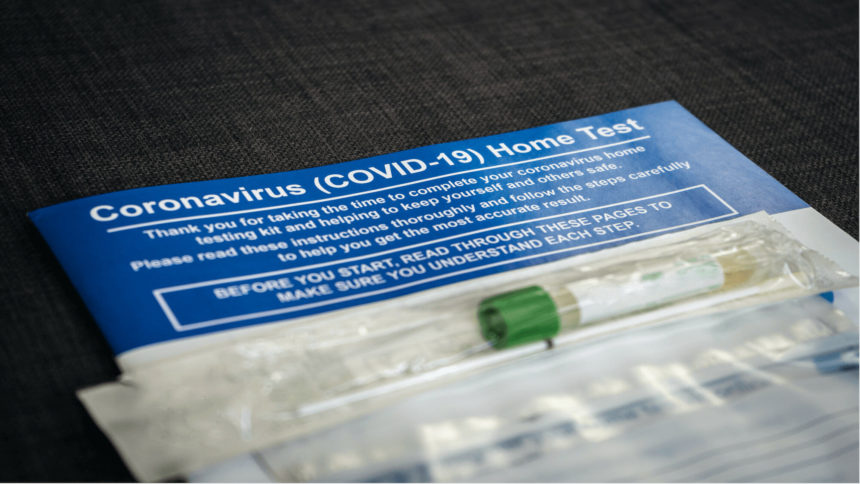 At-home COVID-19 test instructions and package with nasal swab