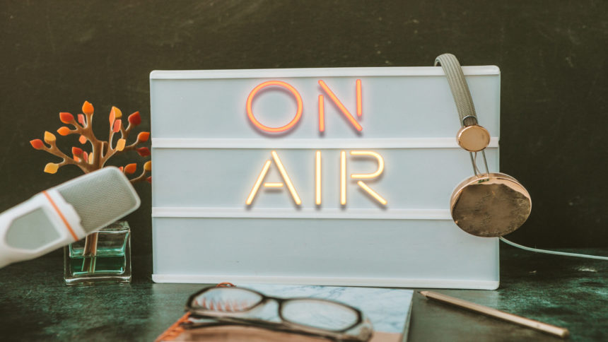 Image of microphone, earphones and "on air" sign
