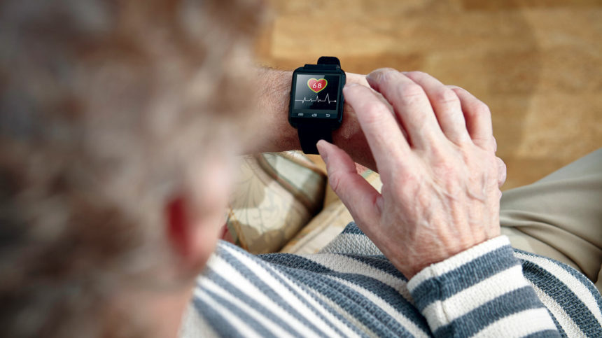 older adult looking at smart watch