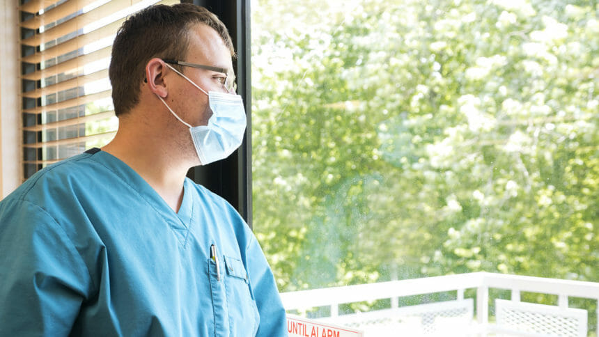 Healthcare worker looks out the window