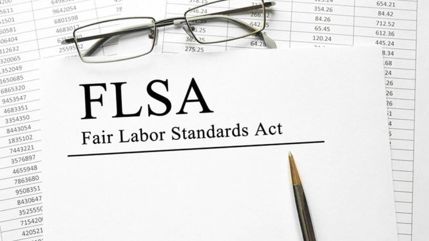 Paper with Fair Labor Standarts Act FLSA on a table