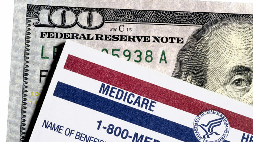 Medicare card sits on top of $100 bill