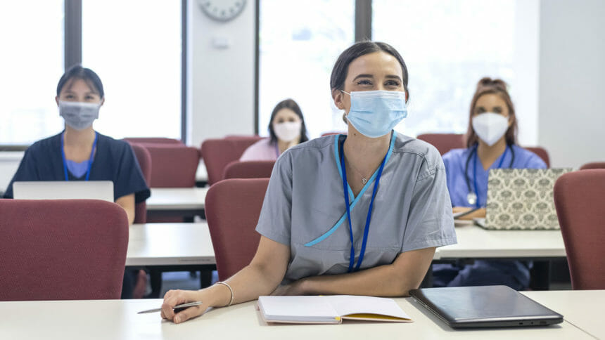Masked nurses at table for orientation