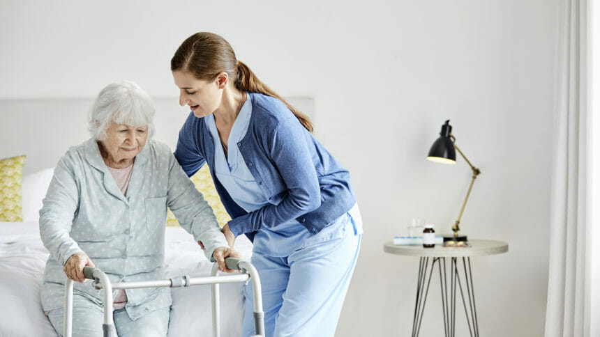 Nursing helping woman with walker