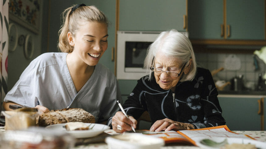 Caregiver helping senior woman