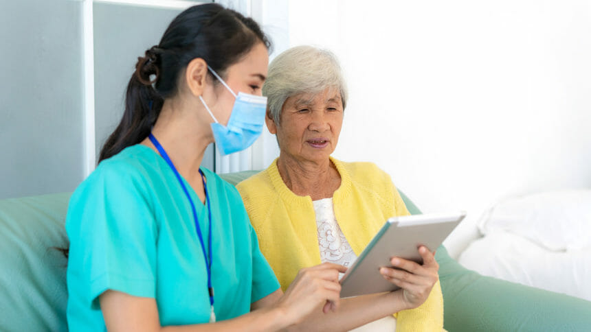 Nurse consulting with patient on Ipad