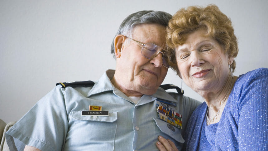 man in military uniform embracing woman