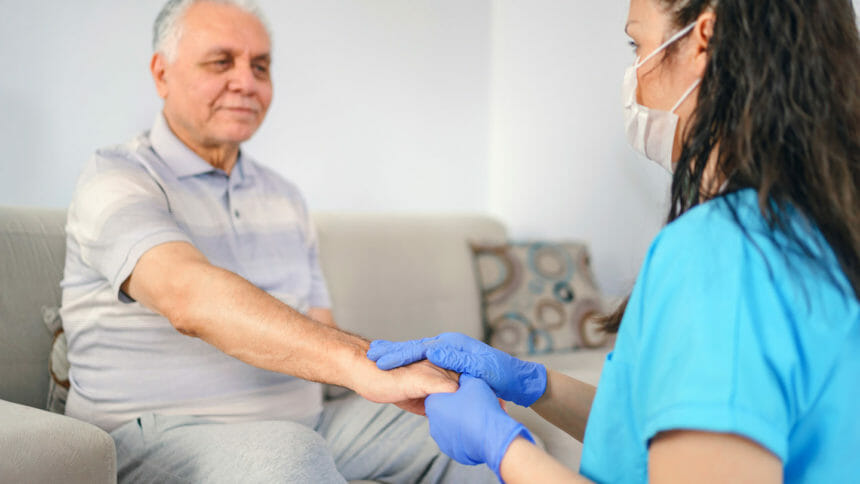 holding patient's hand for health care trust and support