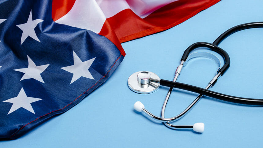 Doctor's stethoscope and US flag on a blue background