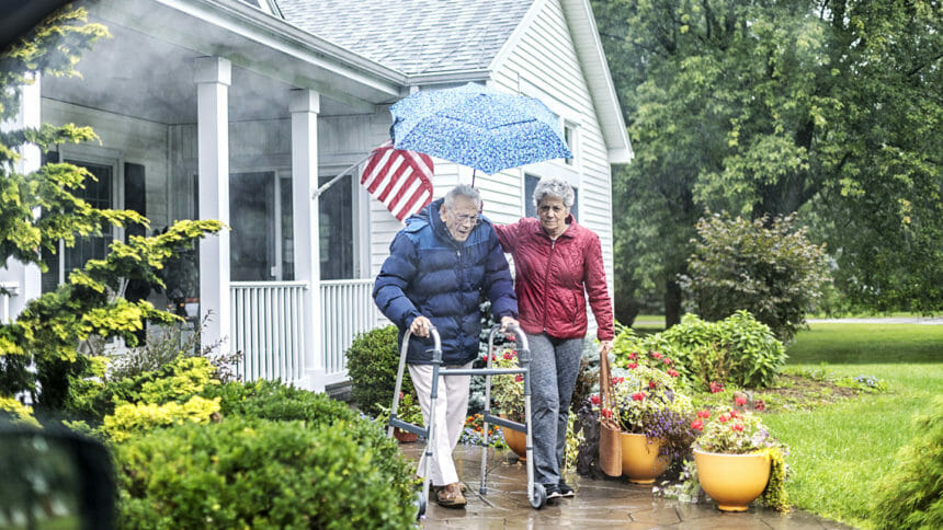 veteran and caregiver walking outside home
