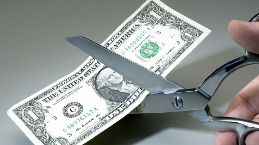 dollar bill being cut