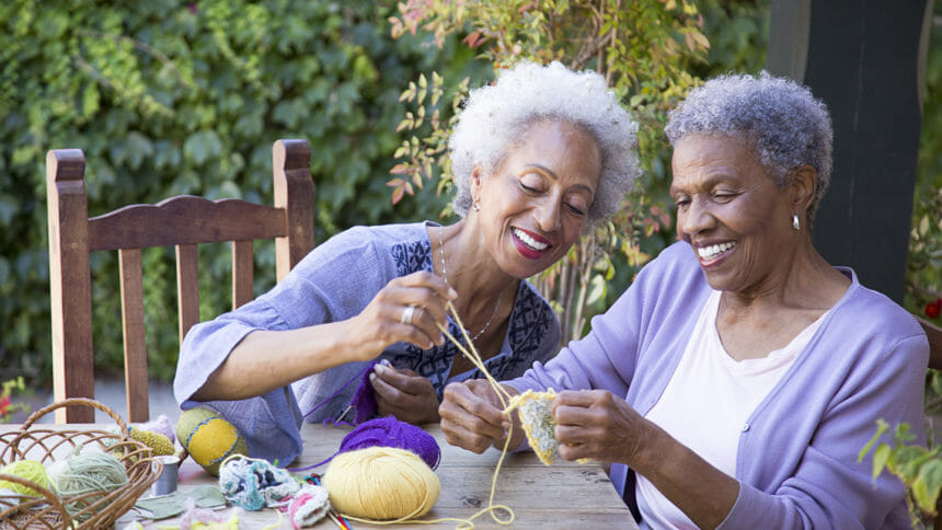 Black women knitting outdoors