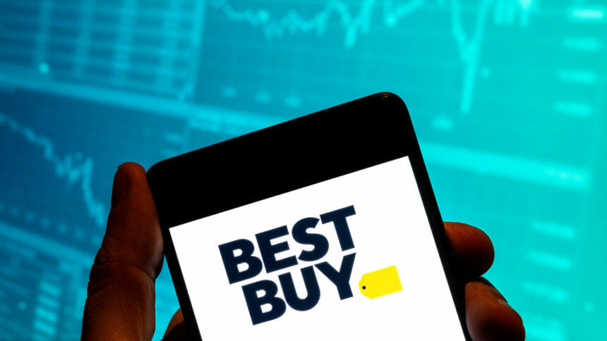 Best Buy logo on smartphone set against stock index graph image