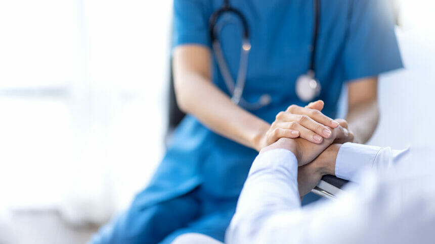 nurse holding patient's hands