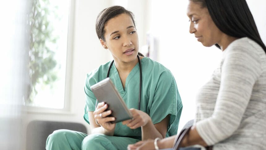 Nurse and patient using digital tablet