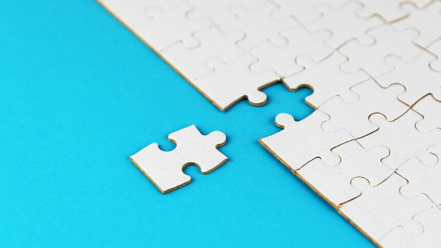The final piece of a jigsaw puzzle shown just outside the rest of the puzzle, representing an acquisition.