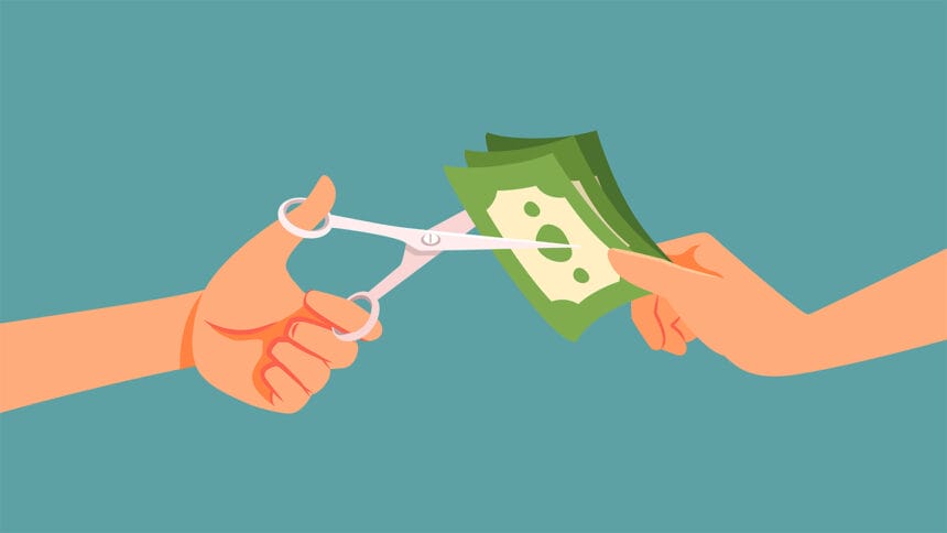 cartoon image of one hand holding a stack of dollar bills while another hand snips the money with scissors, symbolizing a payment cut